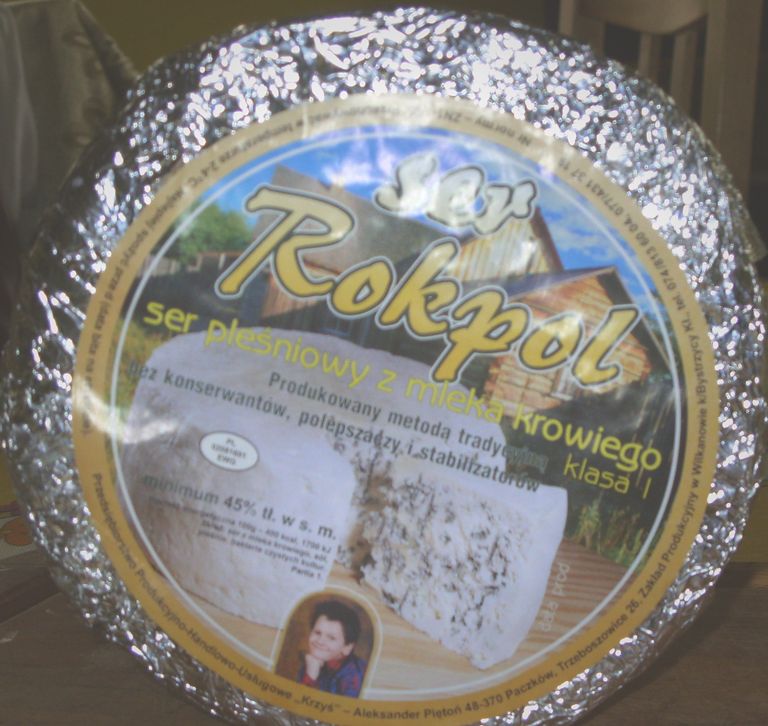 Cały krąg sera w folii aluminiowej z etykietą